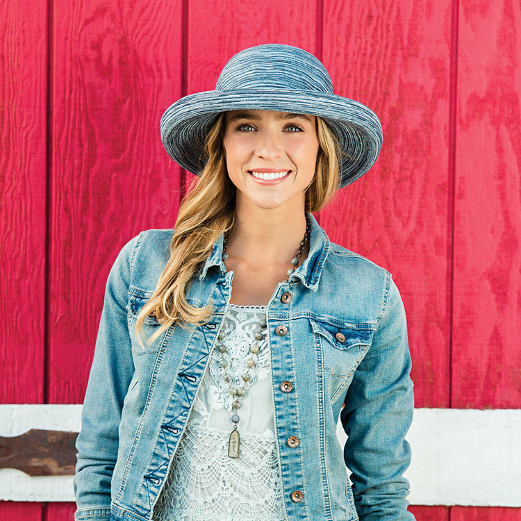 Woman sporting the Sydney summer hat by Wallaroo with an upturned brim, wtith UPF 50 rating, Denim