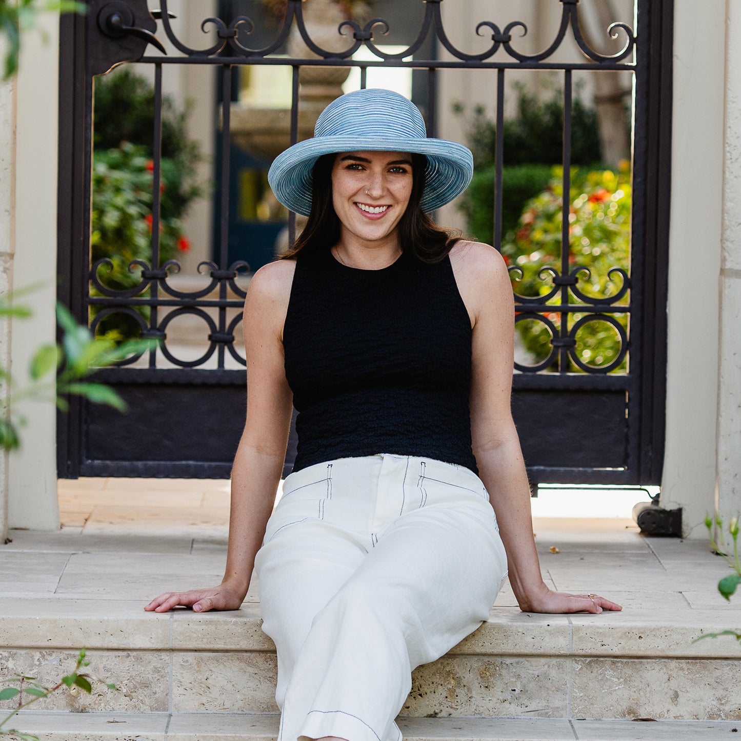 Woman wearing a Sydney blue round crown hat sitting on steps outdoors, Light Blue