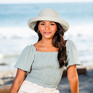 Woman wearing a wide brim summer beach hat by Wallaroo, Seafoam