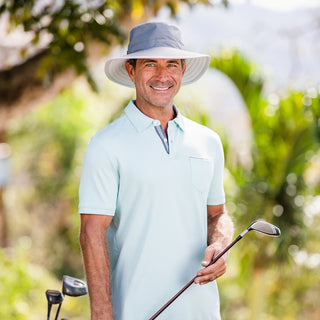 Man wearing the Carkella Tahoe Bucket Sun Hat while playing golf, providing UV protection and a secure fit for sunny days on the course, Dark Grey/Stone