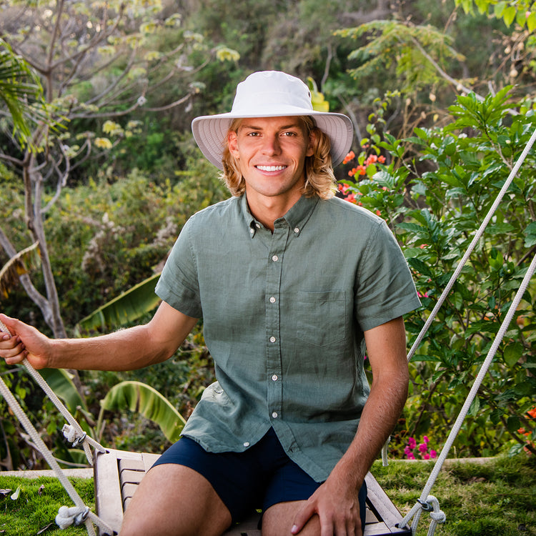 Man wearing the Carkella Tahoe Bucket Sun Hat while enjoying a summers day, providing sun protection and comfort for long hours spent on the water, White/Grey