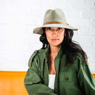 Woman sporting the Wallaroo Telluride Fedora Sun Hat, a perfect accessory for sunny countryside escapes, Sage