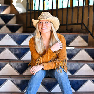 Woman ejoying a summer music festival staying stylish and shaded under the Wallaroo Tina Cowboy Sun Hat, a raffia straw design perfect for warm, sunny days, Natural