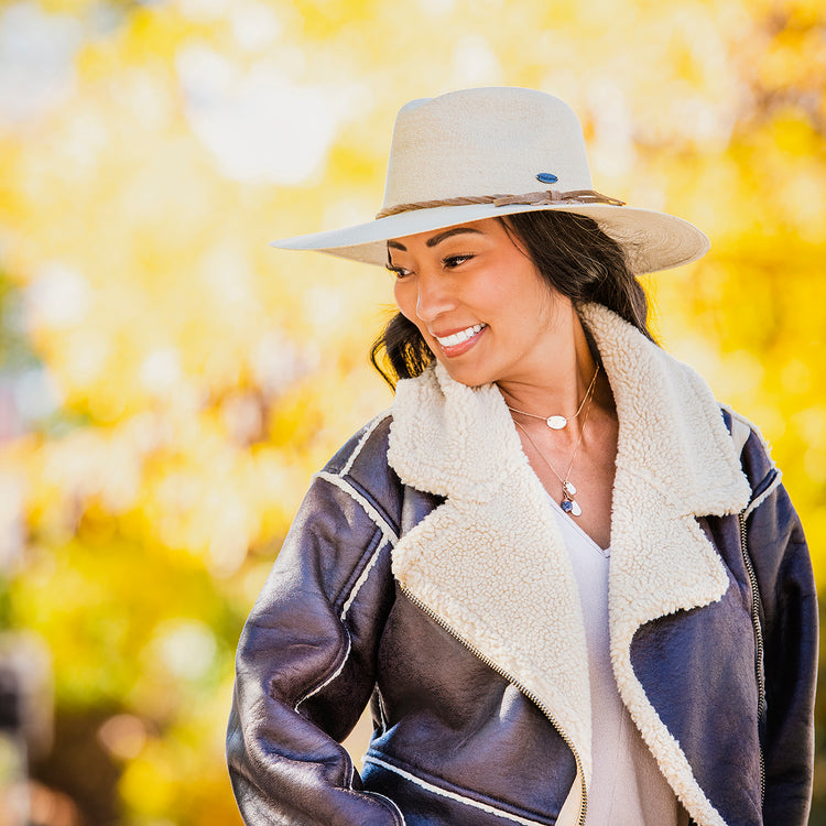 Woman Wearing Unisex Big Wide Brim Fedora Style Tulum Straw Sun Hat from Wallaroo, Natural