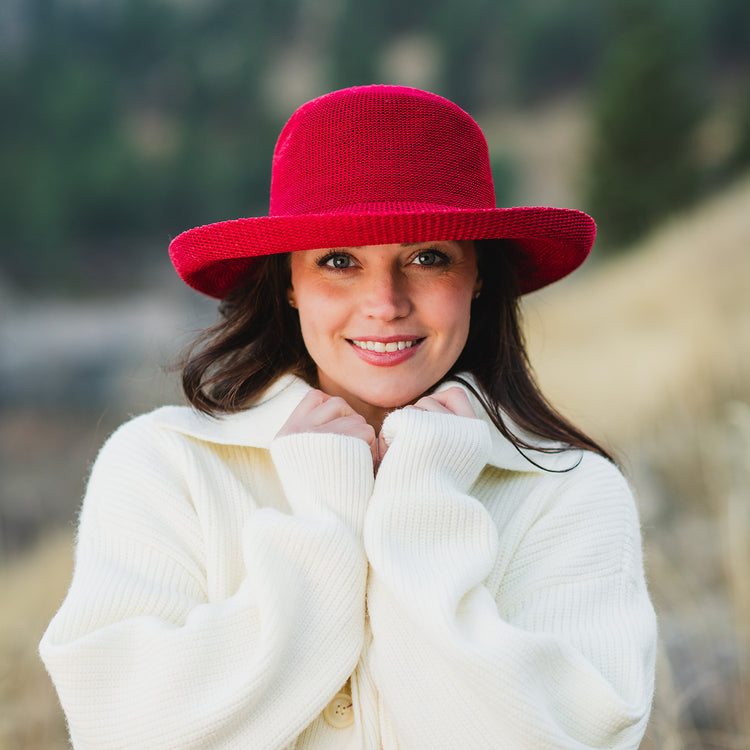 Woman wearing a Cranberry Victoria big wide brim sun hat outside by Wallaroo