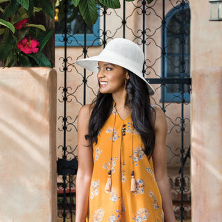 Woman outside sporting a Victoria Diva straw sun hat by Wallaroo with a big wide brim, White