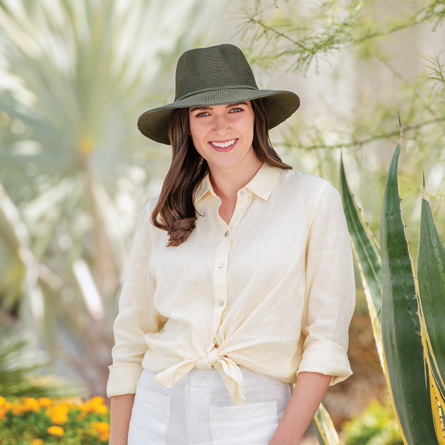 Woman wearing Victoria Fedora in front of plants, Olive
