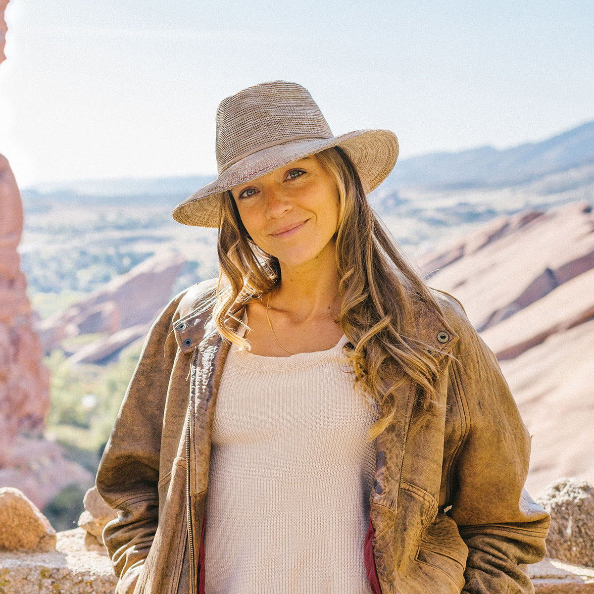 Woman on a sunny day, accessorized with the Wallaroo Victoria Fedora XL Sun Hat, perfect for summer coastal getaways, extra large, Black