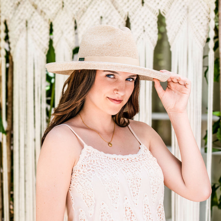 Woman wearing a Big Wide Brim Fedora Style Vivian UPF Sun Hat by Carkella, White Beige