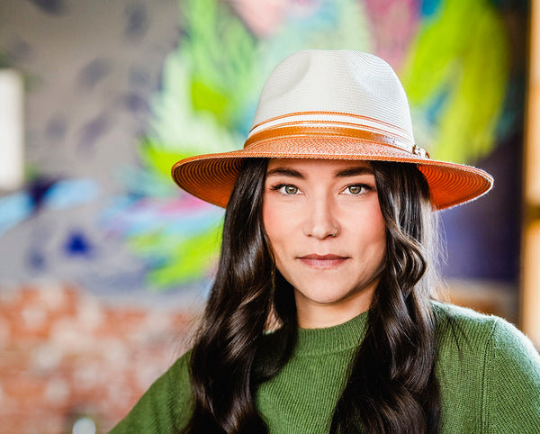 Woman sitting outside while wearing a wide brim fedora sun hat by Wallaroo