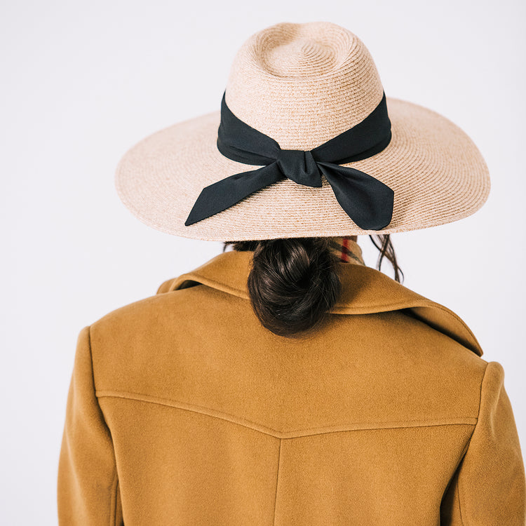 Woman Wearing UPF Packable Big Wide Brim Fedora Style Elise Sun Hat from Wallaroo, White Beige w/black scarf