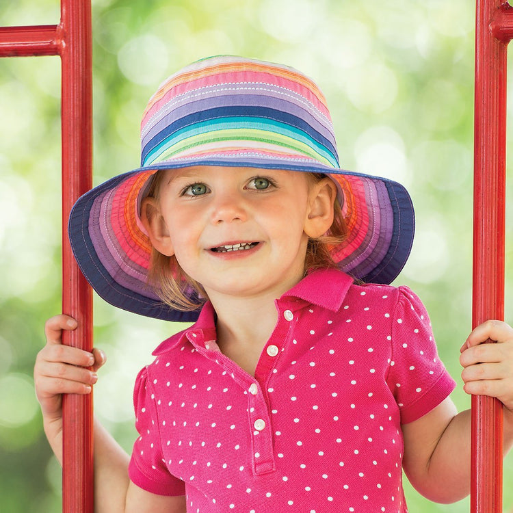 Girl Wearing a Packable Kid's Petite Nantucket UPF Sun Hat in Rainbow Tones from Wallaroo
