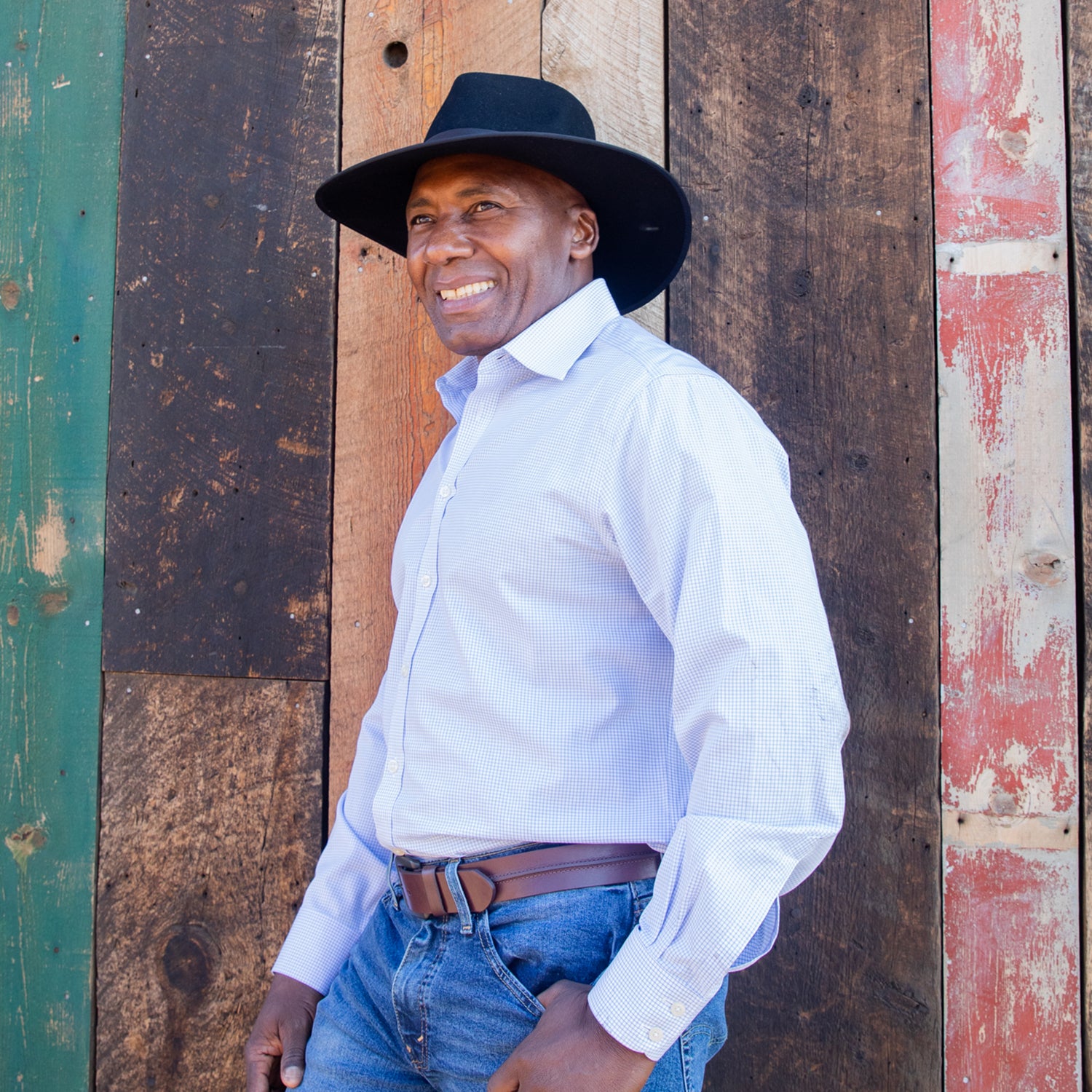 Man Wearing Unisex Felt Wide Brim Fedora Style Sloan UPF Sun Hat from Wallaroo. Black