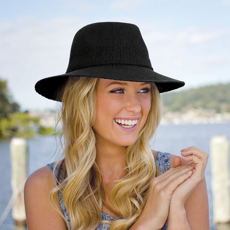 Woman Wearing Packable Fedora Style Victoria Fedora poly straw Sun Hat in Black from Wallaroo
